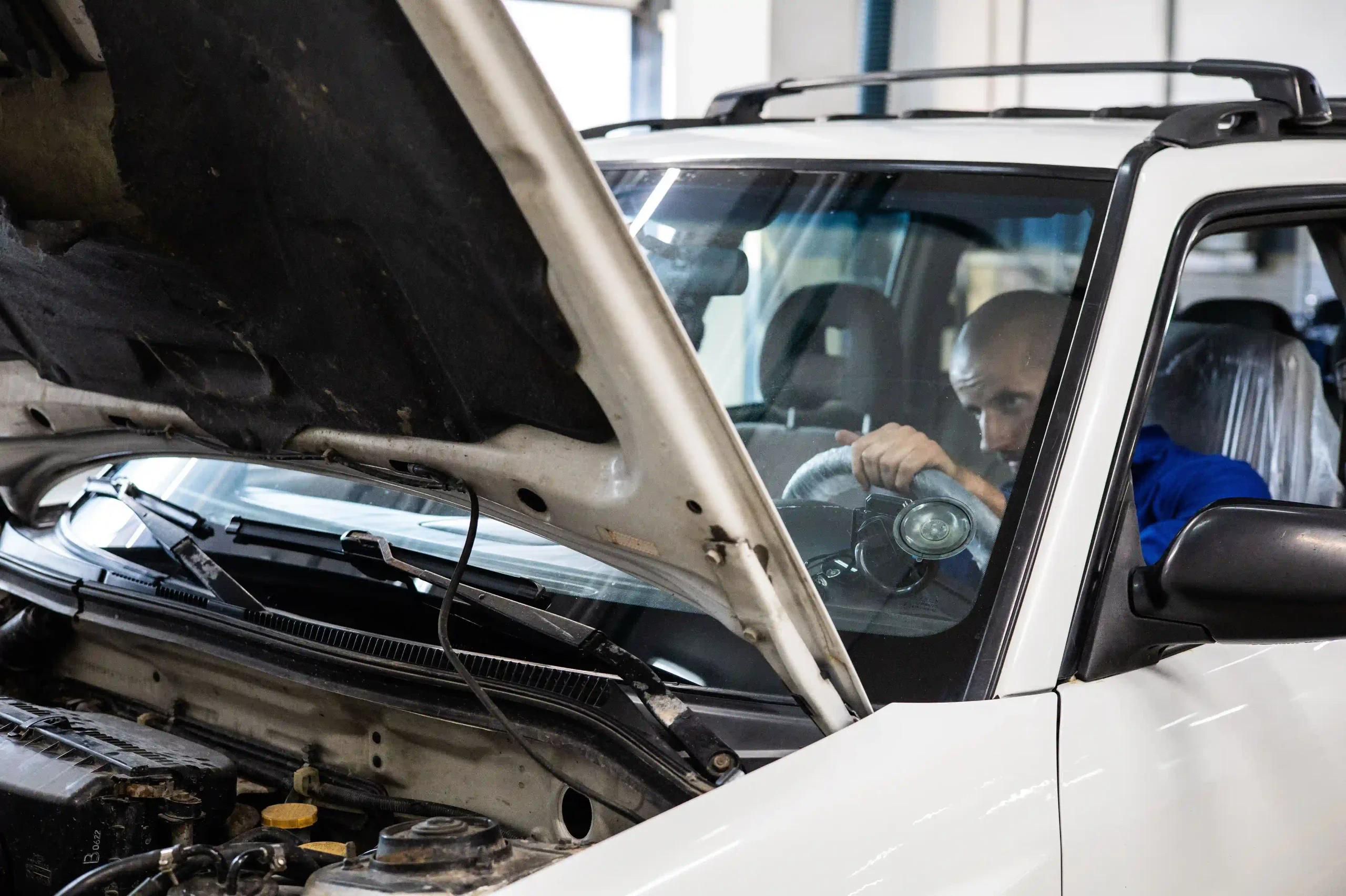 Mechanic inspecting a used European car before purchase