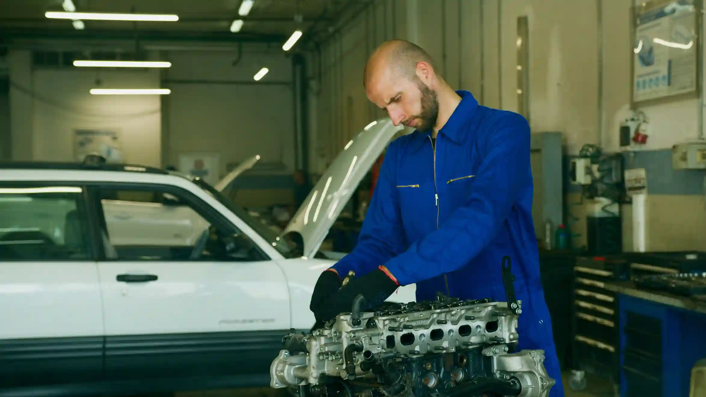 Mechanic checking engine oil level and inspecting the engine