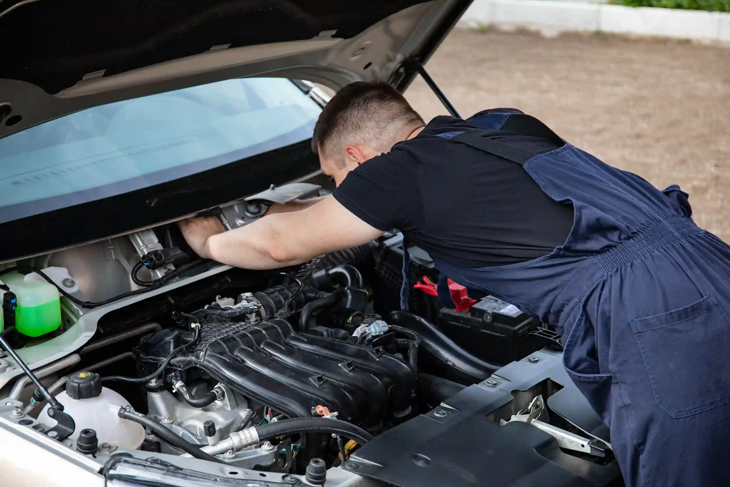 Mechanic inspecting a Volkswagen engine during maintenance
