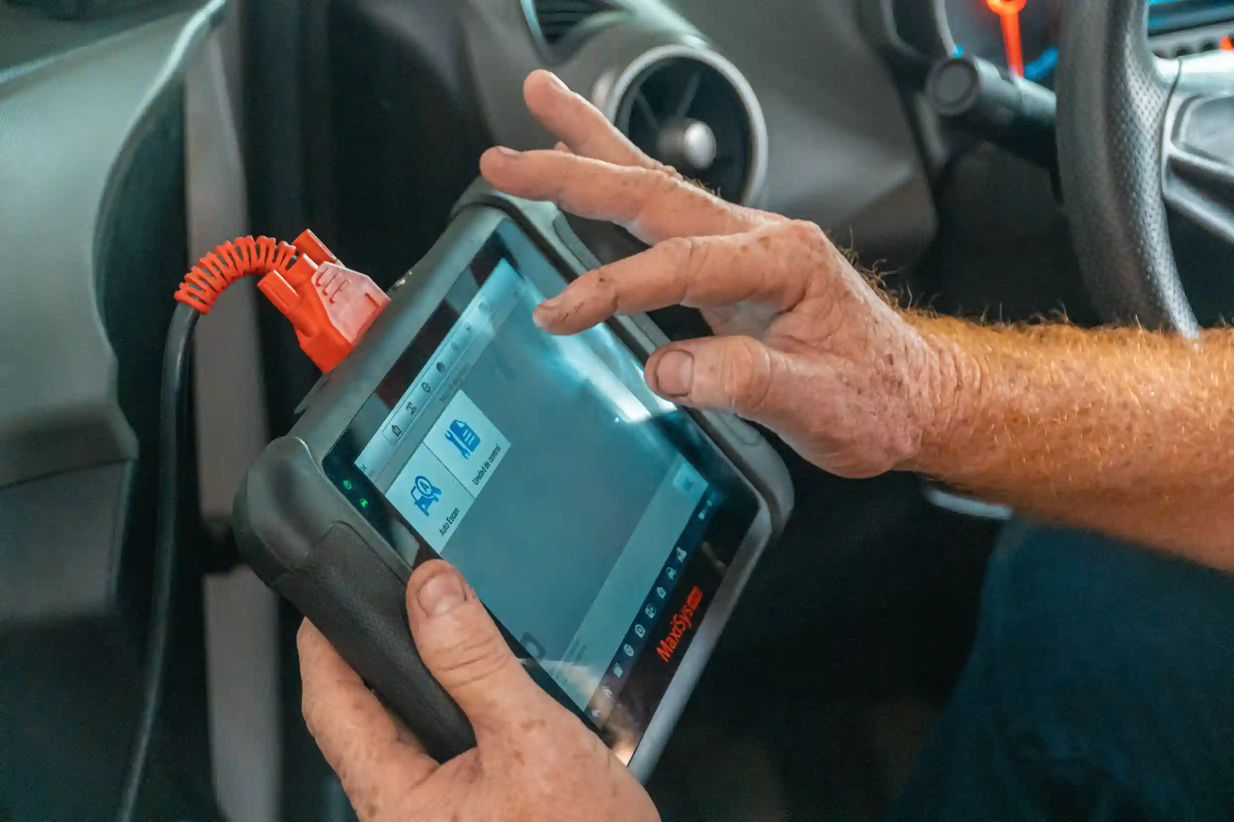 Mechanic using a diagnostic tool to check a car