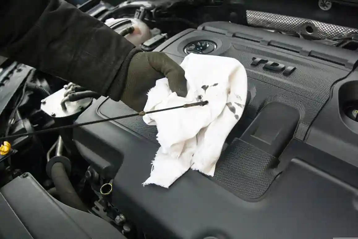 Mechanic performing an engine oil change