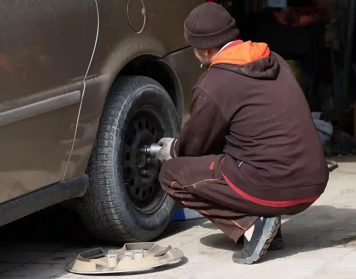 Mechanic performing tire rotation service